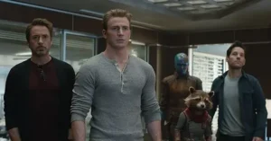 The image depicts a group of characters, including a raccoon in a red vest, standing together in what appears to be a modern office setting.