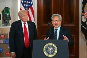 The image shows two individuals standing at a podium with the seal of the President of the United States, with one person speaking and the other standing beside them.