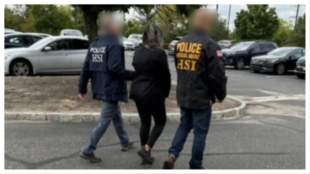 The image shows two law enforcement officers in "POLICE HSI" jackets escorting a person in a parking lot.