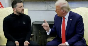 The image shows two individuals engaged in a conversation, with one person gesturing while the other listens attentively.