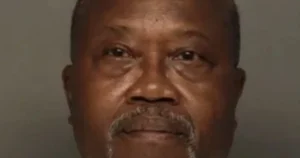 The image appears to be a mugshot of a man with a neutral expression.