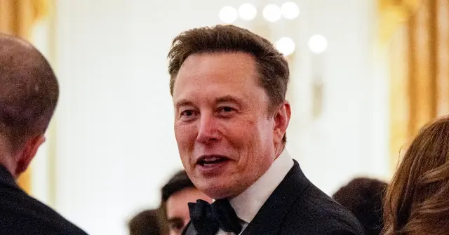 The image shows a man in formal attire, including a bow tie, engaged in conversation at what appears to be a formal event.