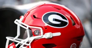 The image shows a close-up of a red football helmet with the Georgia Bulldogs logo prominently displayed.