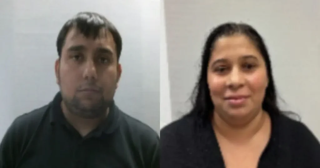 The image shows two individuals, a man and a woman, standing side by side against a plain background.