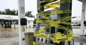 A Cumberland gas station is shown with a fuel pump covered in yellow caution tape, indicating restricted access or a safety precaution.