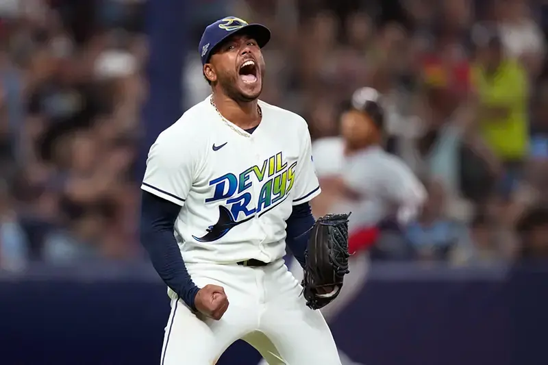 A baseball player in a Tampa Bay Devil Rays uniform celebrates enthusiastically on the field.