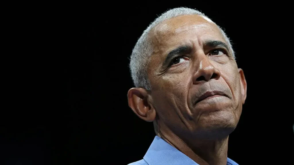 The image shows a close-up of a man with a serious expression, looking upwards.