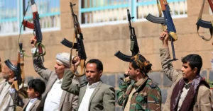A group of individuals raises their weapons in a public display, possibly as a demonstration or protest.