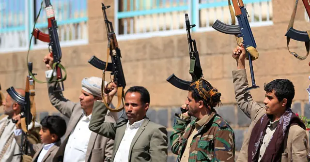 A group of individuals raises their weapons in a public display, possibly as a demonstration or protest.