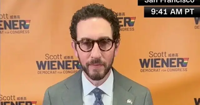 The news photo features a man in a suit and tie standing in front of a backdrop with the name "Scott Wiener" and the text "Democrat for Congress."
