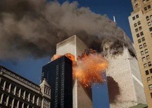The image depicts a dramatic explosion and collapse of a high-rise building, with thick smoke and debris filling the sky.