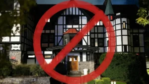 A red "no" symbol is superimposed over a building, possibly indicating a prohibition or restriction related to the location.