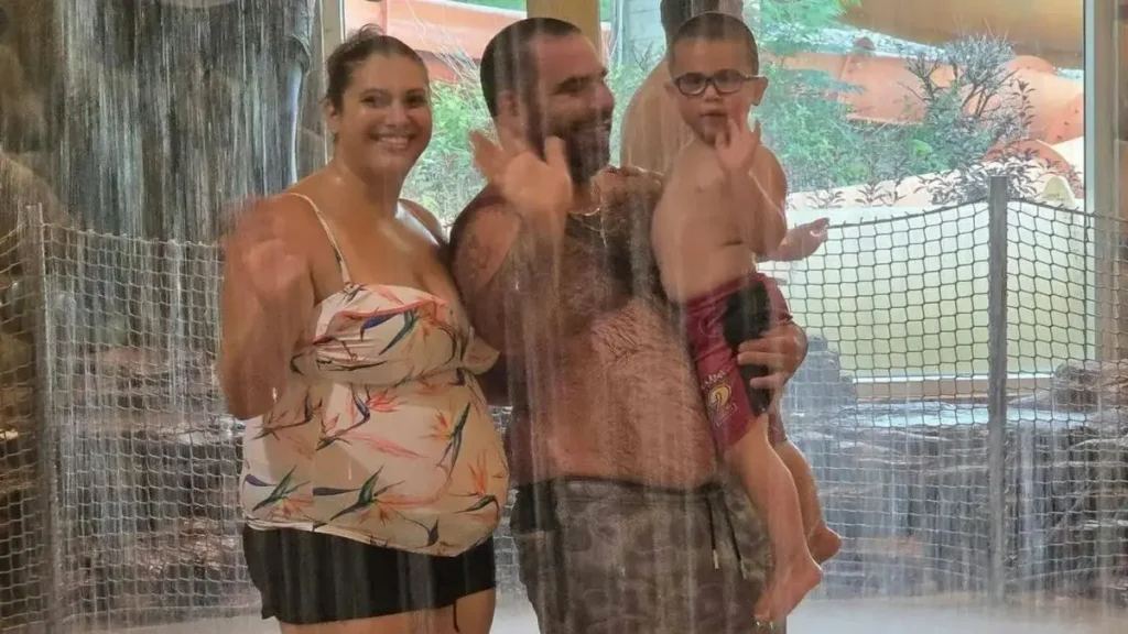 A family enjoys a relaxing moment together in a spa or water park setting.