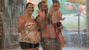 A family enjoys a relaxing moment together in a spa or water park setting.