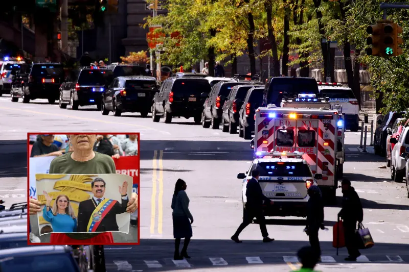 The image shows a busy city street with emergency vehicles and a crowd of people, including one holding a picture of a political figure.