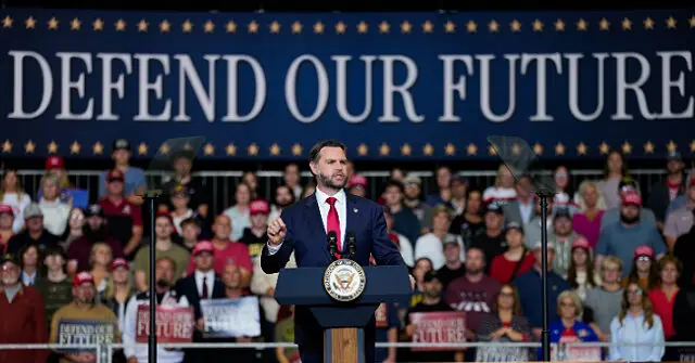 A politician stands at a podium with a "DEFEND OUR FUTURE" banner in the background, addressing a crowd of supporters.