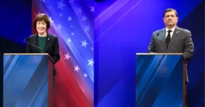 Two individuals stand at podiums in front of a backdrop featuring the American flag, likely participating in a political debate or discussion.