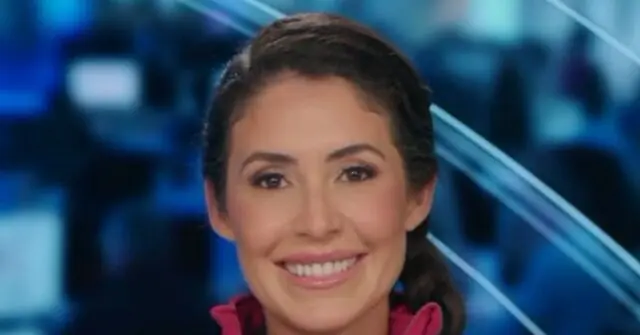 The image shows a smiling news anchor in a studio setting with a blue background.