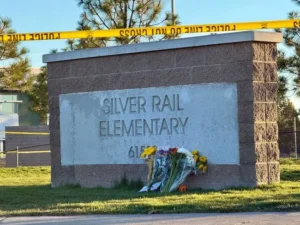 Flowers are placed at the entrance of Silver Rail Elementary School, which is cordoned off with police tape.
