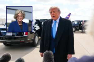 The image shows a man in a suit and tie speaking to reporters, with a vehicle and another person in the background.