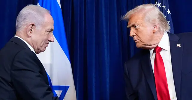 The image shows two individuals in formal attire standing in front of flags, one of which is the Israeli flag, suggesting a diplomatic or political meeting.
