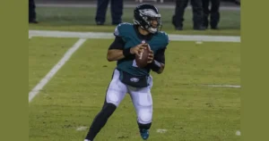 A Philadelphia Eagles quarterback is seen in action, preparing to throw the football during a game.