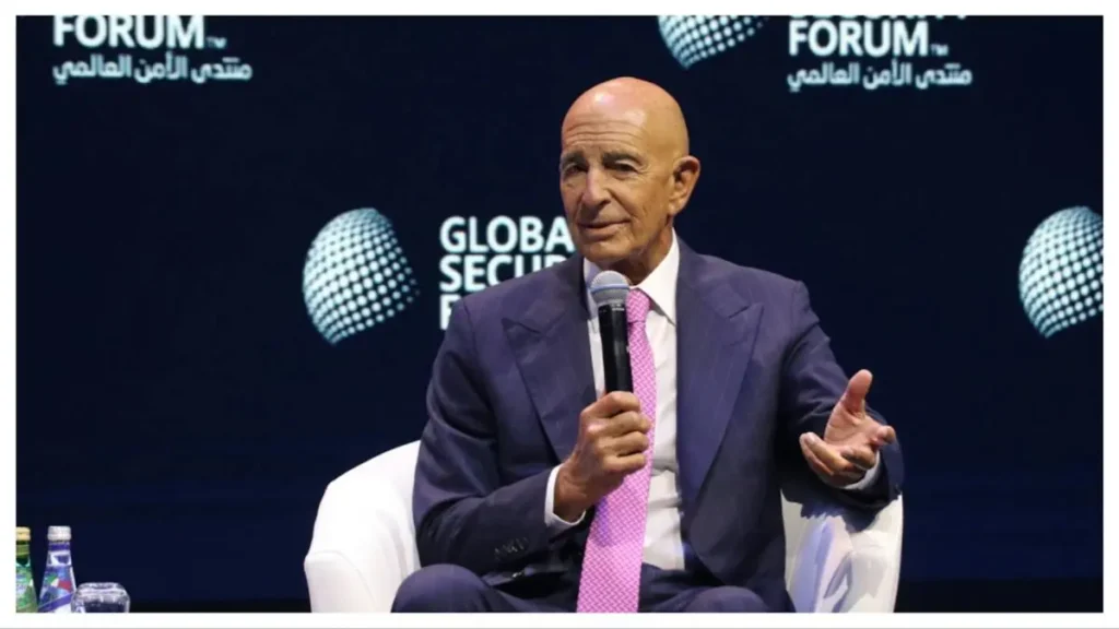 A man in a suit and tie is speaking into a microphone at the Global Security Forum.