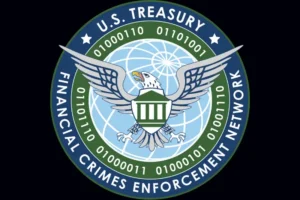 The image shows the logo of the U.S. Treasury Financial Crimes Enforcement Network, featuring an eagle and a shield with binary code around it.