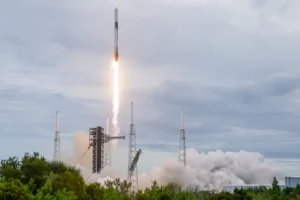 A rocket lifts off from a launchpad, leaving a trail of smoke and fire as it ascends into the sky.