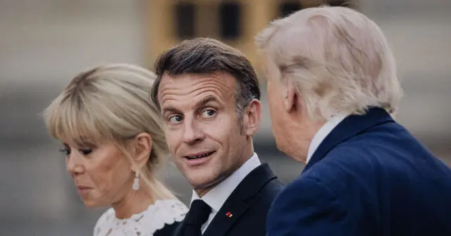 The photo shows three individuals, two men and one woman, dressed formally, standing together in what appears to be a public or official setting.