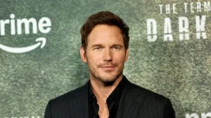 The image shows a man in a suit at a promotional event for "The Terminal List," with the Amazon Prime logo visible in the background.