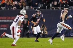 A Chicago Bears quarterback prepares to hand off the ball during a football game.