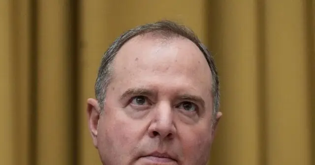 The image shows a close-up of a man with a serious expression, set against a blurred background.