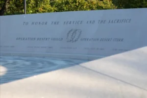 The image shows a memorial plaque honoring the service and sacrifice of those involved in Operation Desert Shield and Operation Desert Storm.