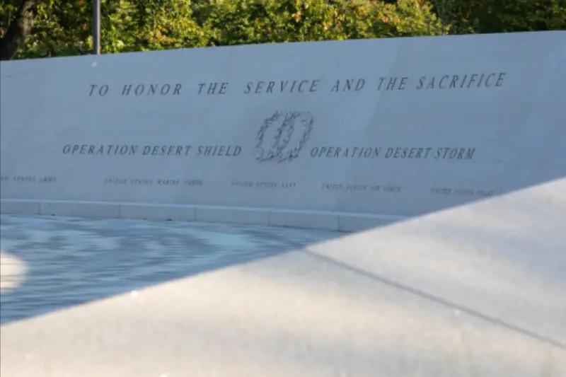 The image shows a memorial plaque honoring the service and sacrifice of those involved in Operation Desert Shield and Operation Desert Storm.