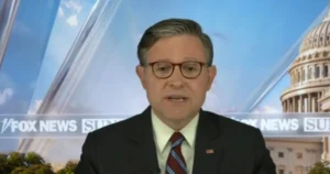 The image shows a news anchor on a Fox News Sunday broadcast, with the Capitol building in the background.