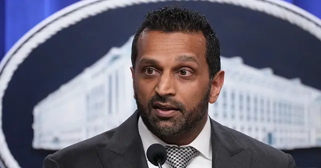 The image shows a man speaking at a podium in front of a backdrop featuring the White House.