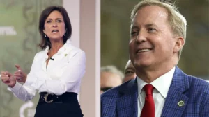 The image shows two individuals, one in a white shirt and black skirt, and the other in a blue plaid suit with a red tie, both appearing to be at a formal event or press conference.