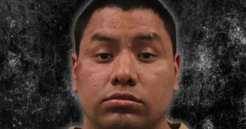 The image appears to be a mugshot of a person against a textured background.