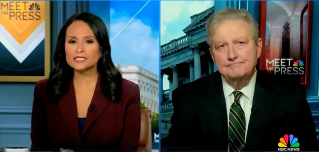The image shows two individuals on a news broadcast, with one person on the left and another on the right, both seated in front of a backdrop featuring the "Meet the Press" logo and a building facade.