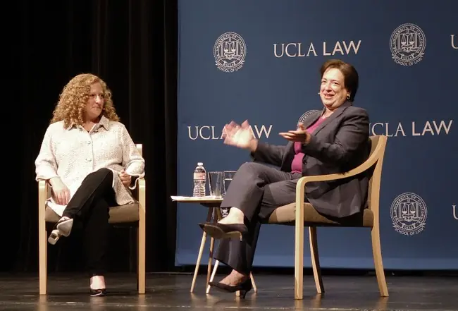 Two women are seated on stage at UCLA Law, engaged in a discussion.