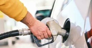 A person is refueling a car at a gas station.
