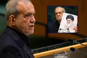 The image shows a man speaking at a podium, with a smaller inset image of another man holding a portrait of a religious leader.