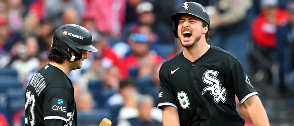 Two Chicago White Sox players celebrate on the field during a game.