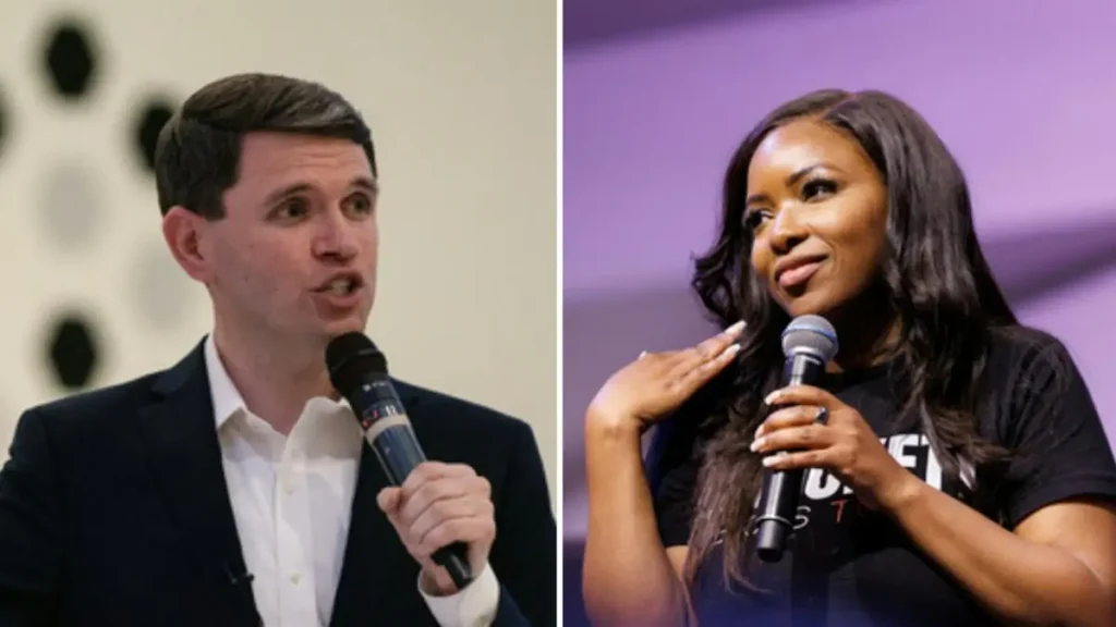 The image shows two individuals speaking into microphones, one dressed in a suit and the other in a casual outfit, suggesting a formal or professional event.