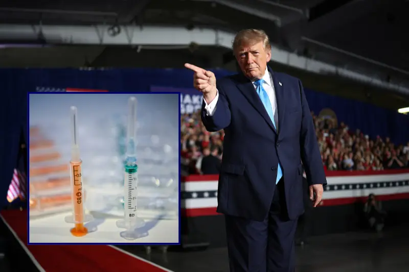 The image shows a political figure in a suit pointing towards a small inset photo of syringes, possibly referencing a discussion about vaccinations or medical procedures.