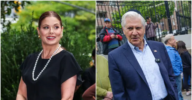 The image shows two individuals, one dressed in a black outfit with a pearl necklace and the other in a blue suit with a yarmulke, standing in front of a fence with other people in the background.