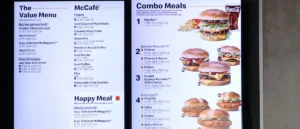 The image shows a McDonald's menu board displaying various meal options, including value menu items, McCafé beverages, and combo meals.