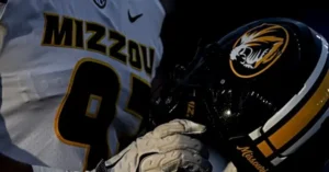 The image shows a close-up of a Missouri football player holding a helmet, wearing a jersey with the number 91.
