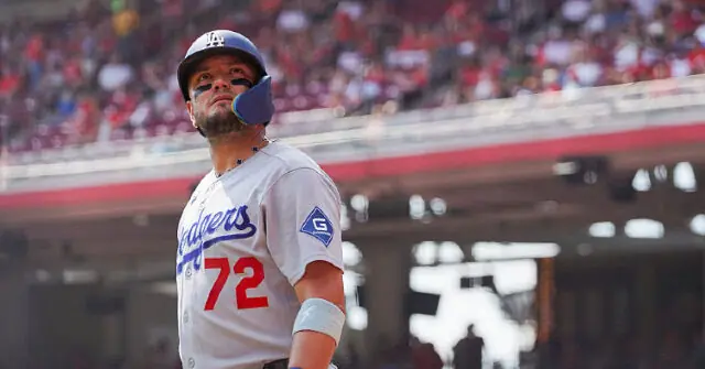 A baseball player wearing a Los Angeles Dodgers uniform with the number 72 is seen in a stadium setting.
